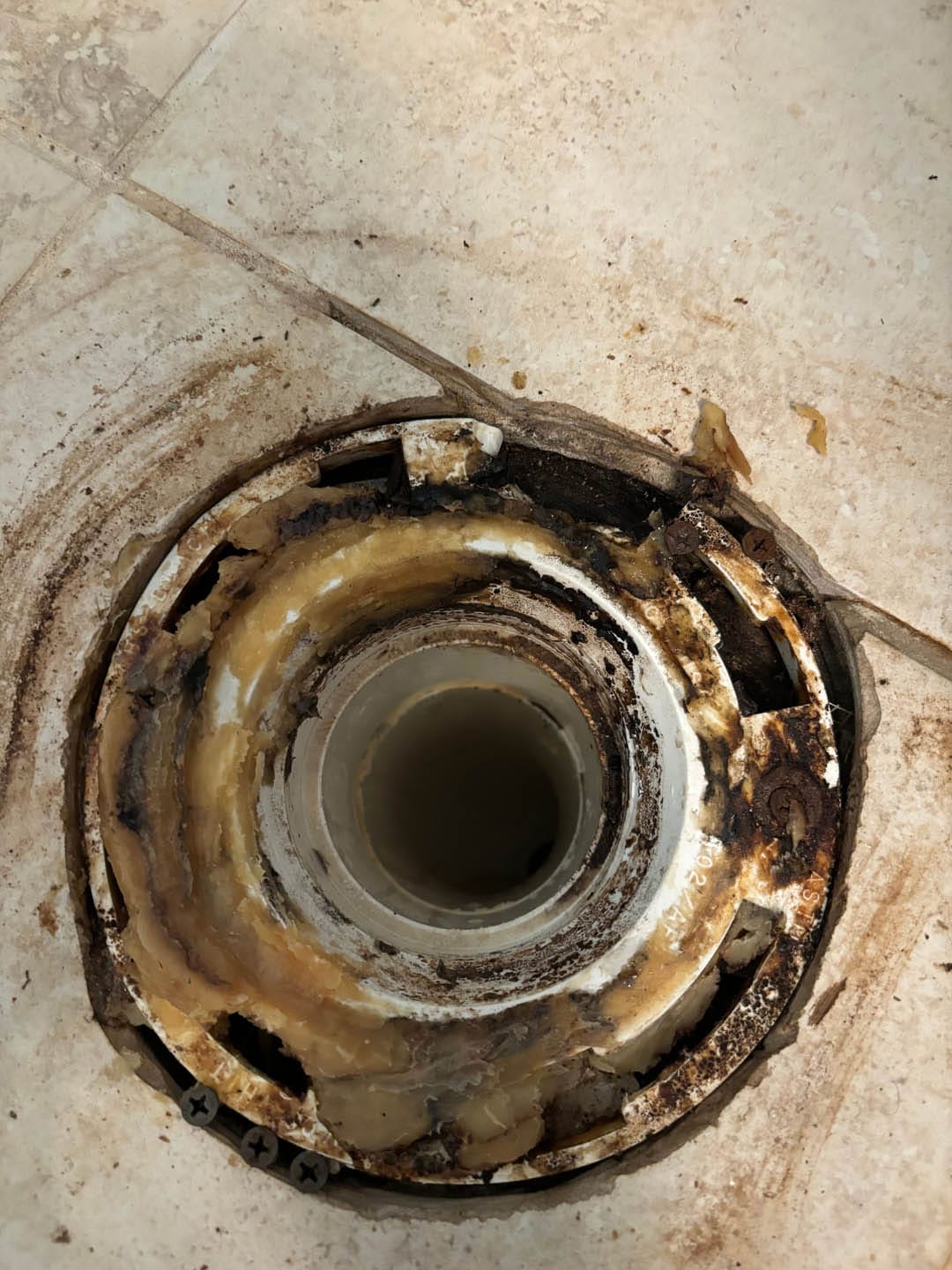 Toilet flange with buildup and corrosion, highlighting plumbing issues related to drain cleaning services in Powder Springs, GA.
