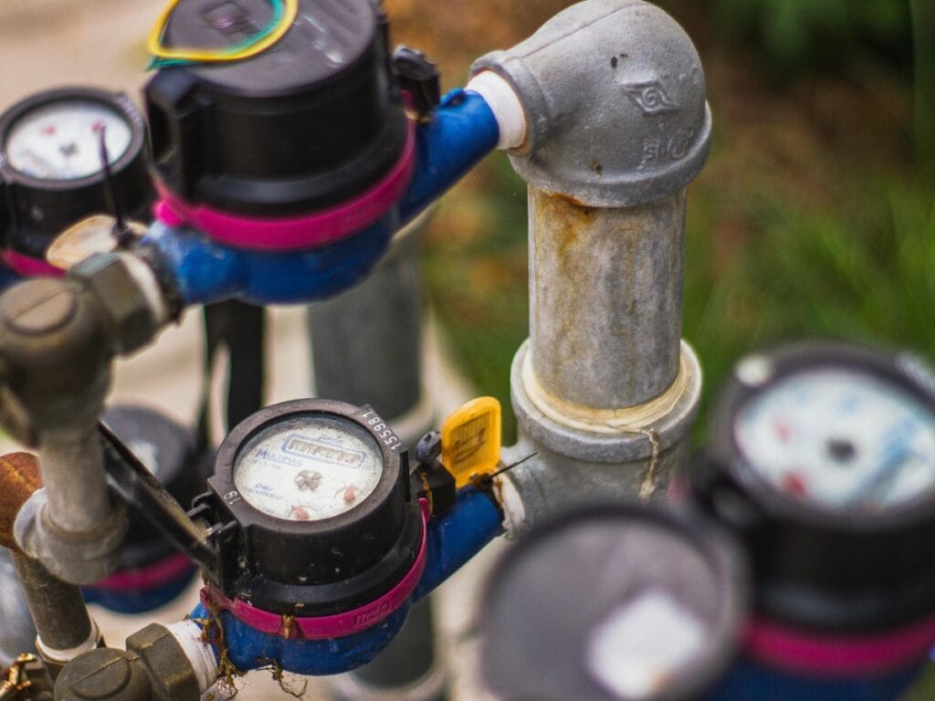 Water pressure gauge and plumbing valves, illustrating low water pressure diagnostics and adjustments for home plumbing systems.