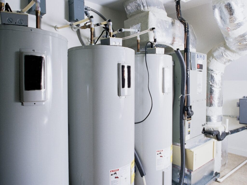 Water heater units with modern insulation and heating technology, showcasing efficient plumbing setup and energy-saving features.